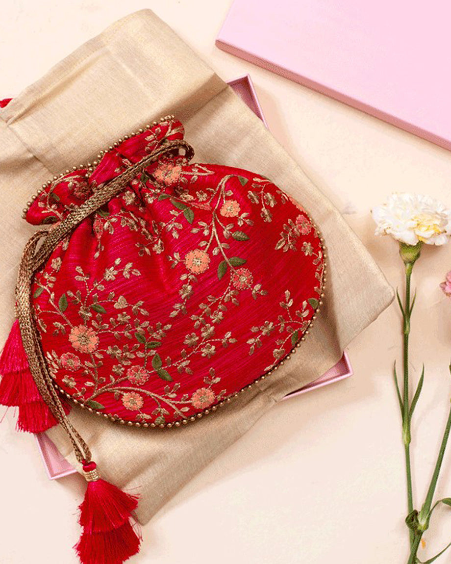 Shop our Handcrafted Floral Creeper Potli with Pastel Floral Embroidery and Cutdana Tassels - Perfect for Traditional and Indo-Western Attire