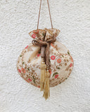 Floral Creeper Cream Potli Bag by AMYRA