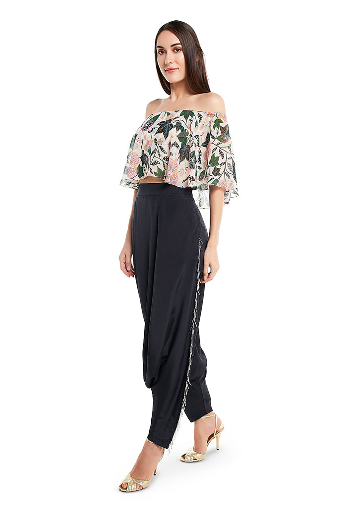 Model wearing white abutilon print off-shoulder top and black art crepe pant